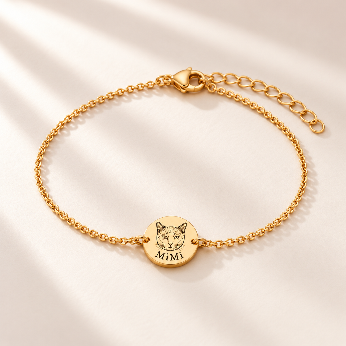 Reference-based AI illustration of a gold-tone fine-chain bracelet with a round MiMi cat portrait tag.